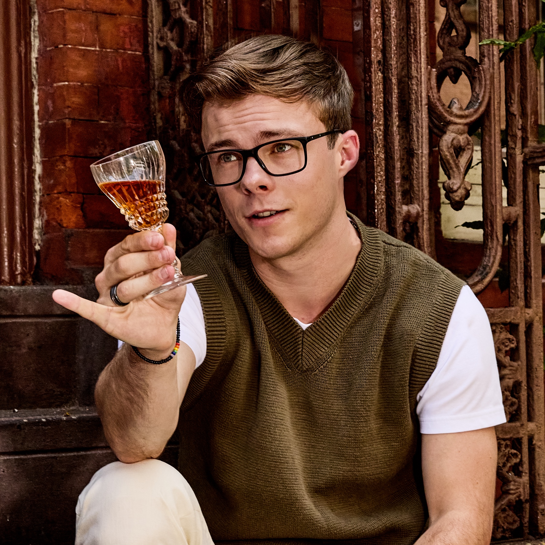 Nicholas Hamilton holding a cocktail